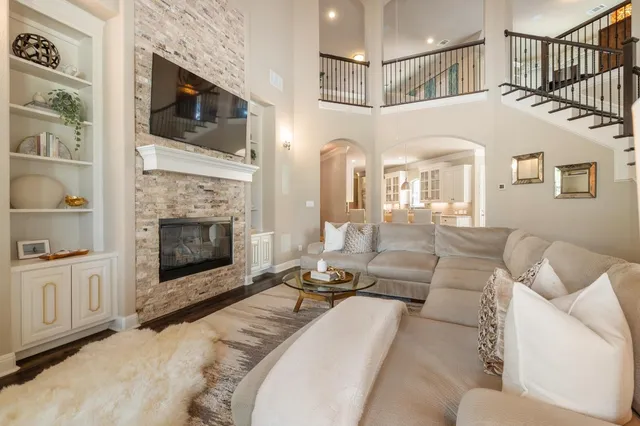 a living room with furniture a flat screen tv and a fireplace
