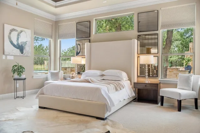 a spacious bedroom with a bed and a large window