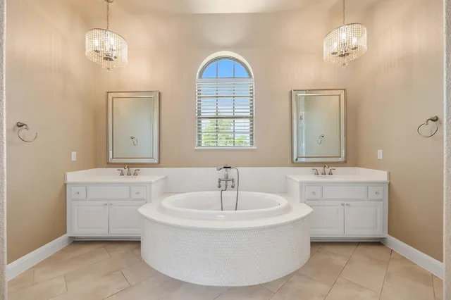 a spacious bathroom with a sink and a mirror