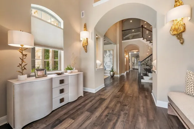 a kitchen with stainless steel appliances a stove top oven and wooden floor