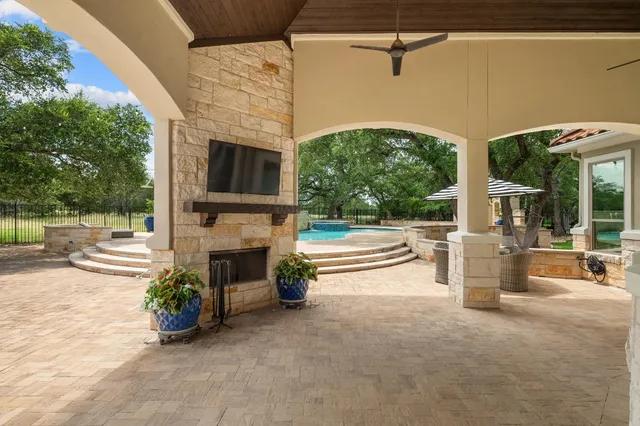 a view of a patio with couches fire pit and a yard