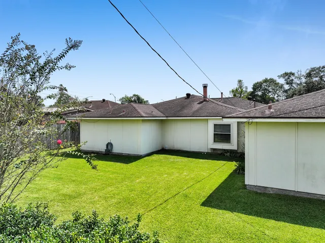 a view of a house with pool and a yard
