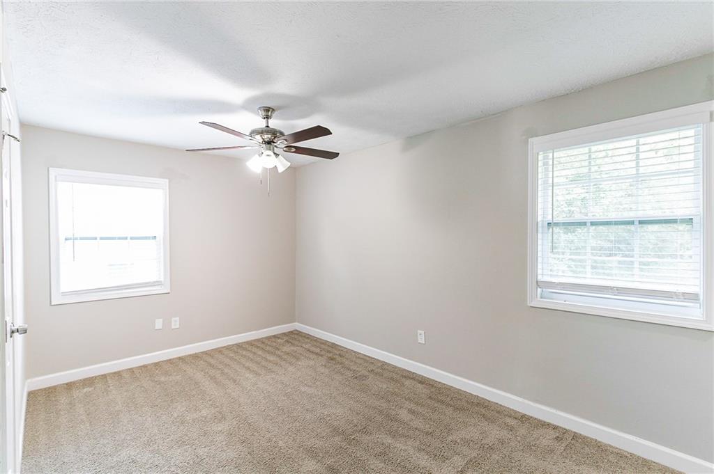 1669 Freedom Valley Decatur, GA 30032 - Photo 12 of 27 an empty room with a window and a fan
