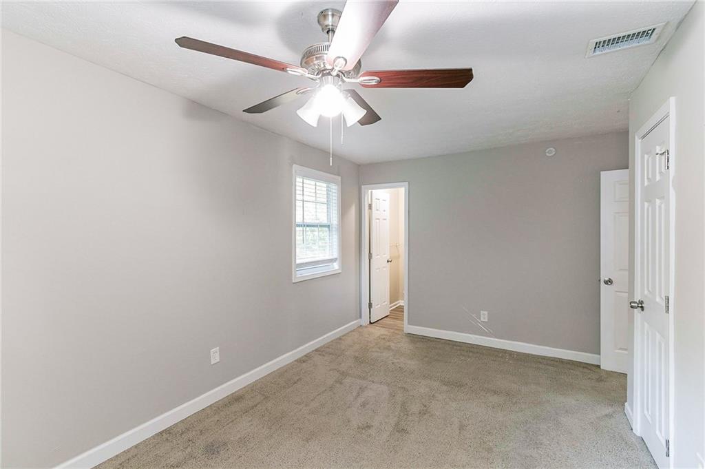 1669 Freedom Valley Decatur, GA 30032 - Photo 13 of 27 an empty room with windows and fan