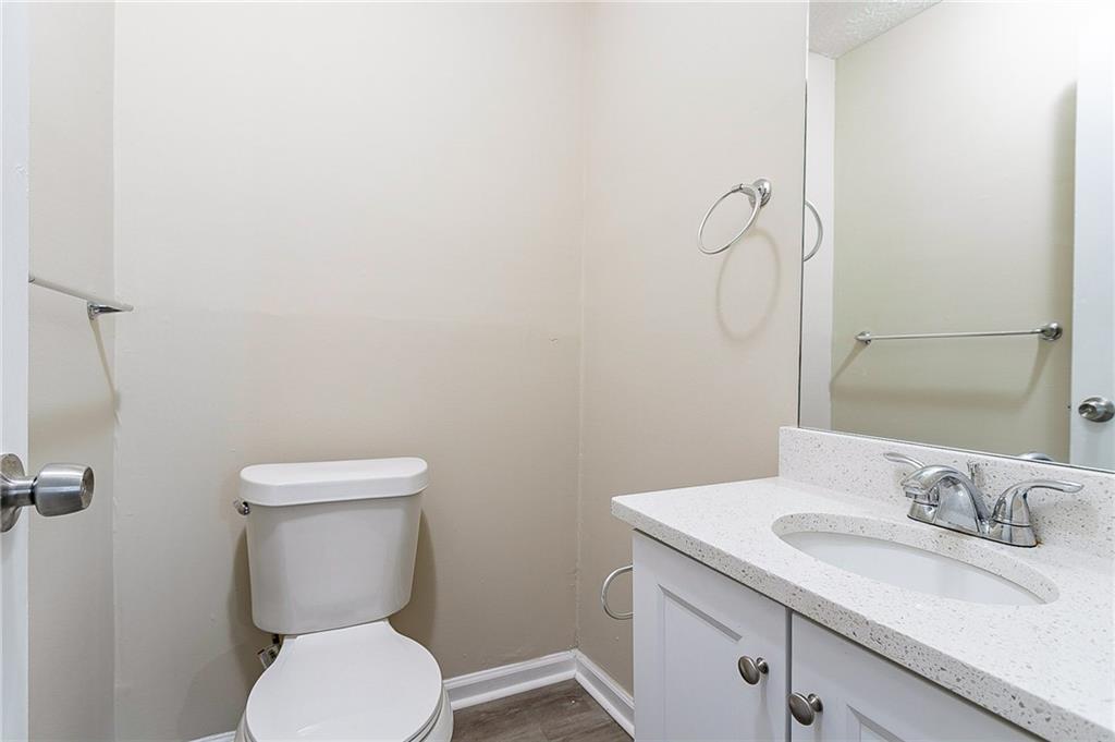 1669 Freedom Valley Decatur, GA 30032 - Photo 14 of 27 a bathroom with a granite countertop toilet sink and mirror