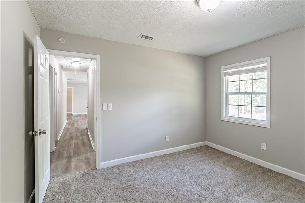 1669 Freedom Valley Decatur, GA 30032 - Photo 16 of 27 an empty room with windows and closet