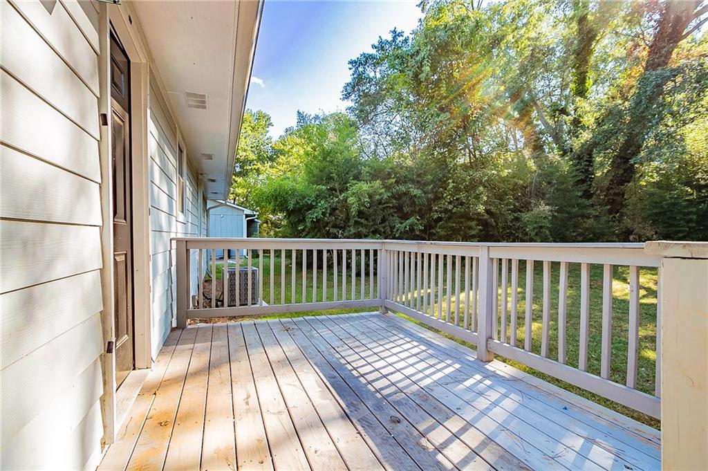 1669 Freedom Valley Decatur, GA 30032 - Photo 21 of 27 a balcony with wooden floor and fence