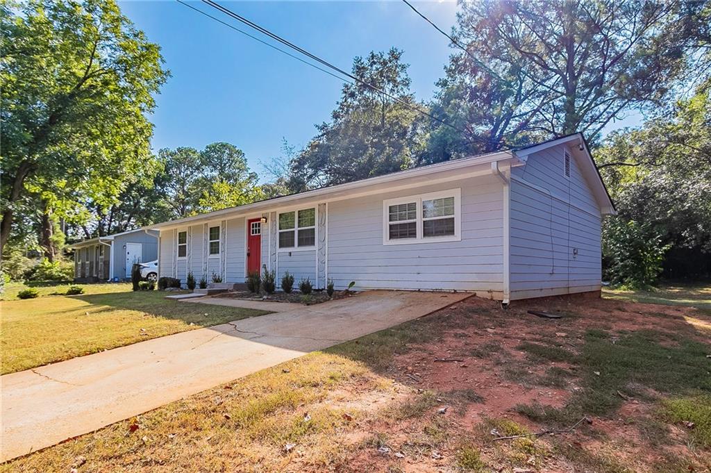 1669 Freedom Valley Decatur, GA 30032 - Photo 3 of 27 a view of a yard with a house and a tree