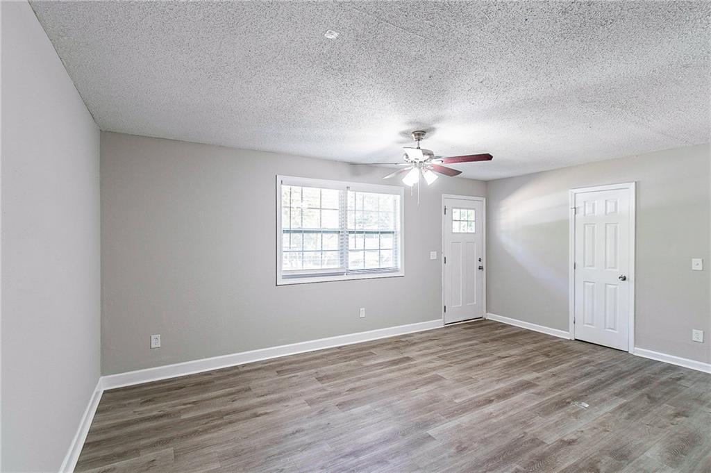 1669 Freedom Valley Decatur, GA 30032 - Photo 4 of 27 a view of an empty room with wooden floor and a window