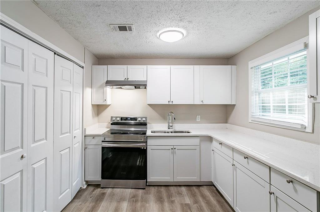 1669 Freedom Valley Decatur, GA 30032 - Photo 6 of 27 a kitchen with a stove oven and sink