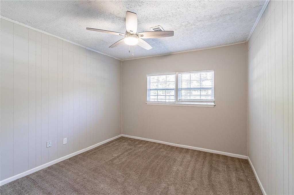 1669 Freedom Valley Decatur, GA 30032 - Photo 9 of 27 an empty room with a window and a fan