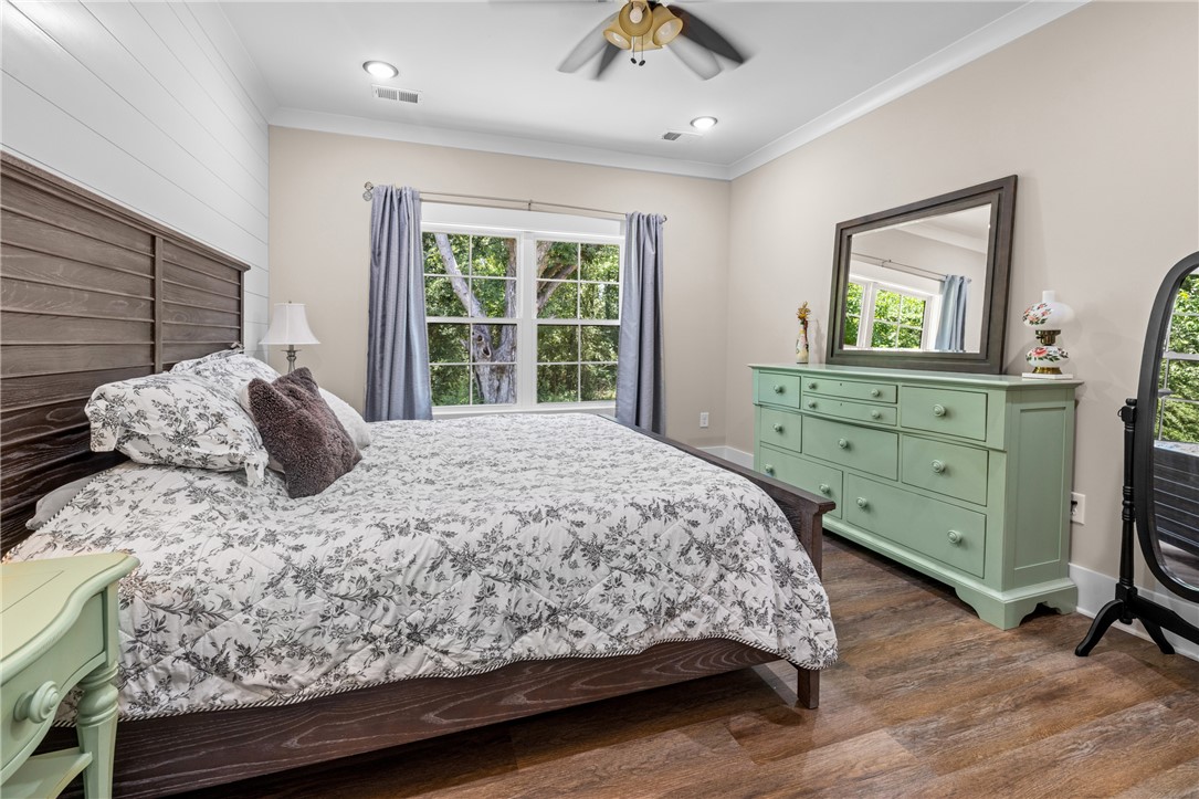 322 Thompson Street Pendleton, SC 29670 - Photo 23 of 38 Rich floors and elegant crown molding elevate this serene primary bedroom.