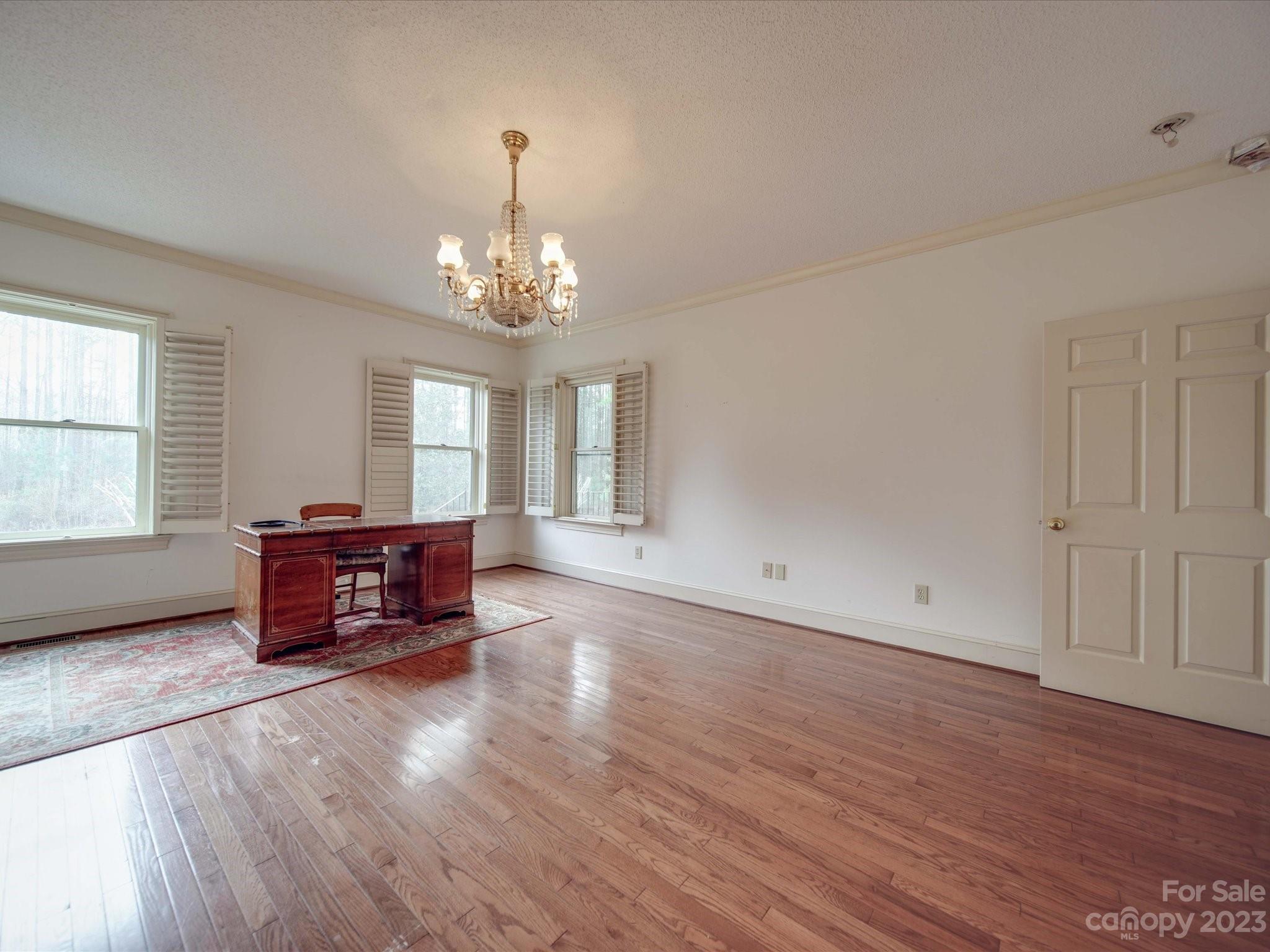1939 Neel Road Salisbury, NC 28147 - Photo 20 of 48 an empty room with wooden floor and windows