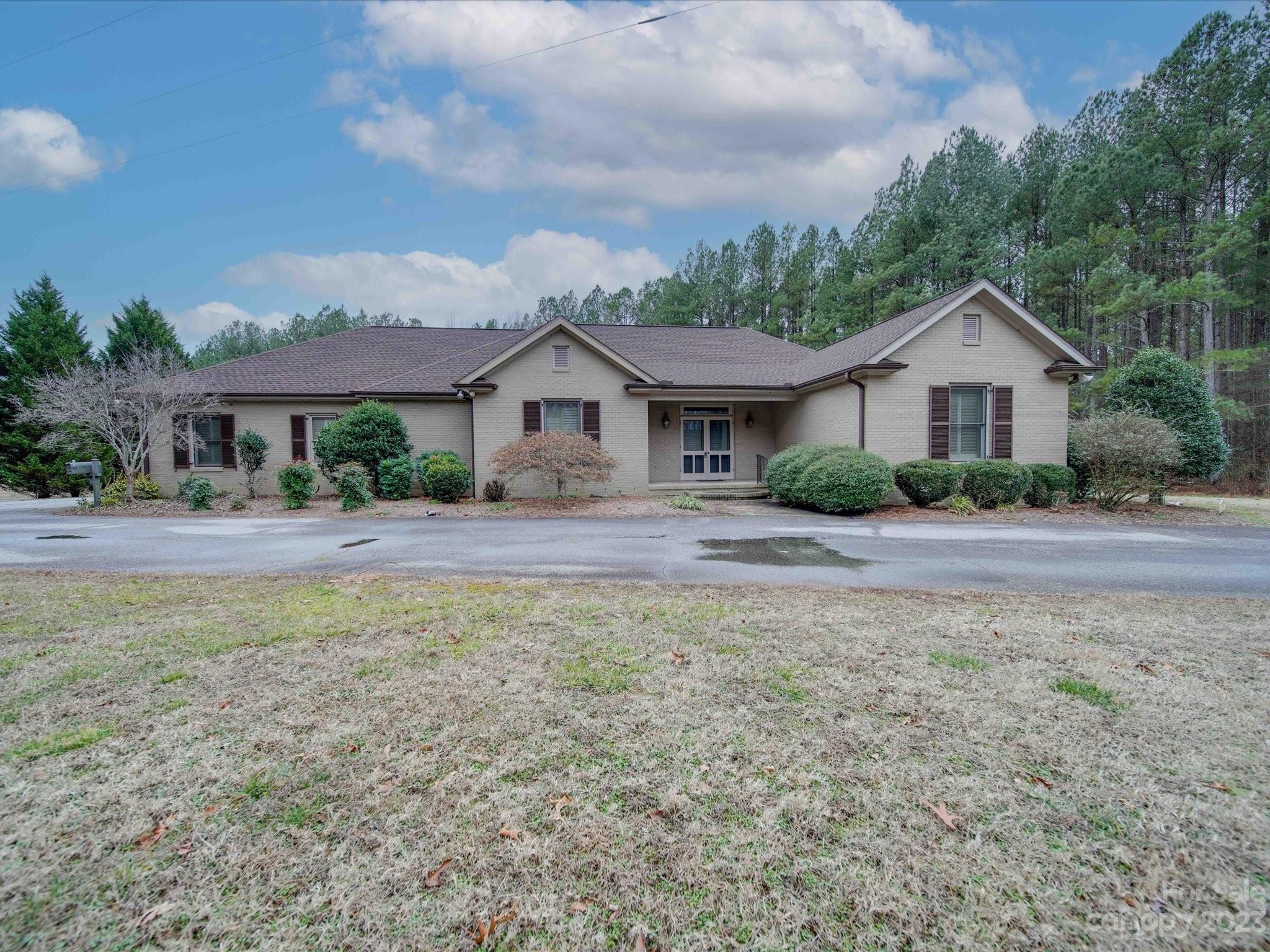 1939 Neel Road Salisbury, NC 28147 - Photo 2 of 48 a front view of a house with a yard and trees