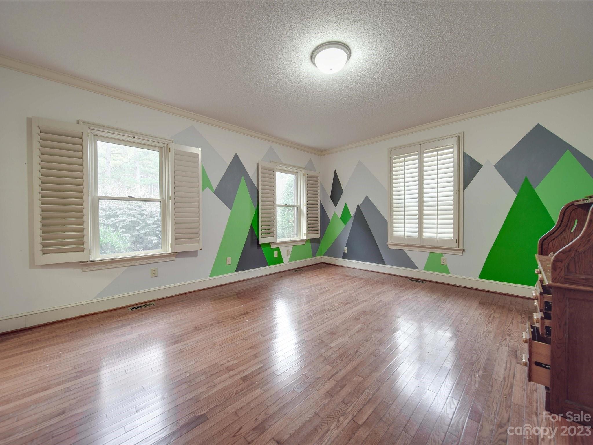 1939 Neel Road Salisbury, NC 28147 - Photo 28 of 48 an empty room with wooden floor and windows