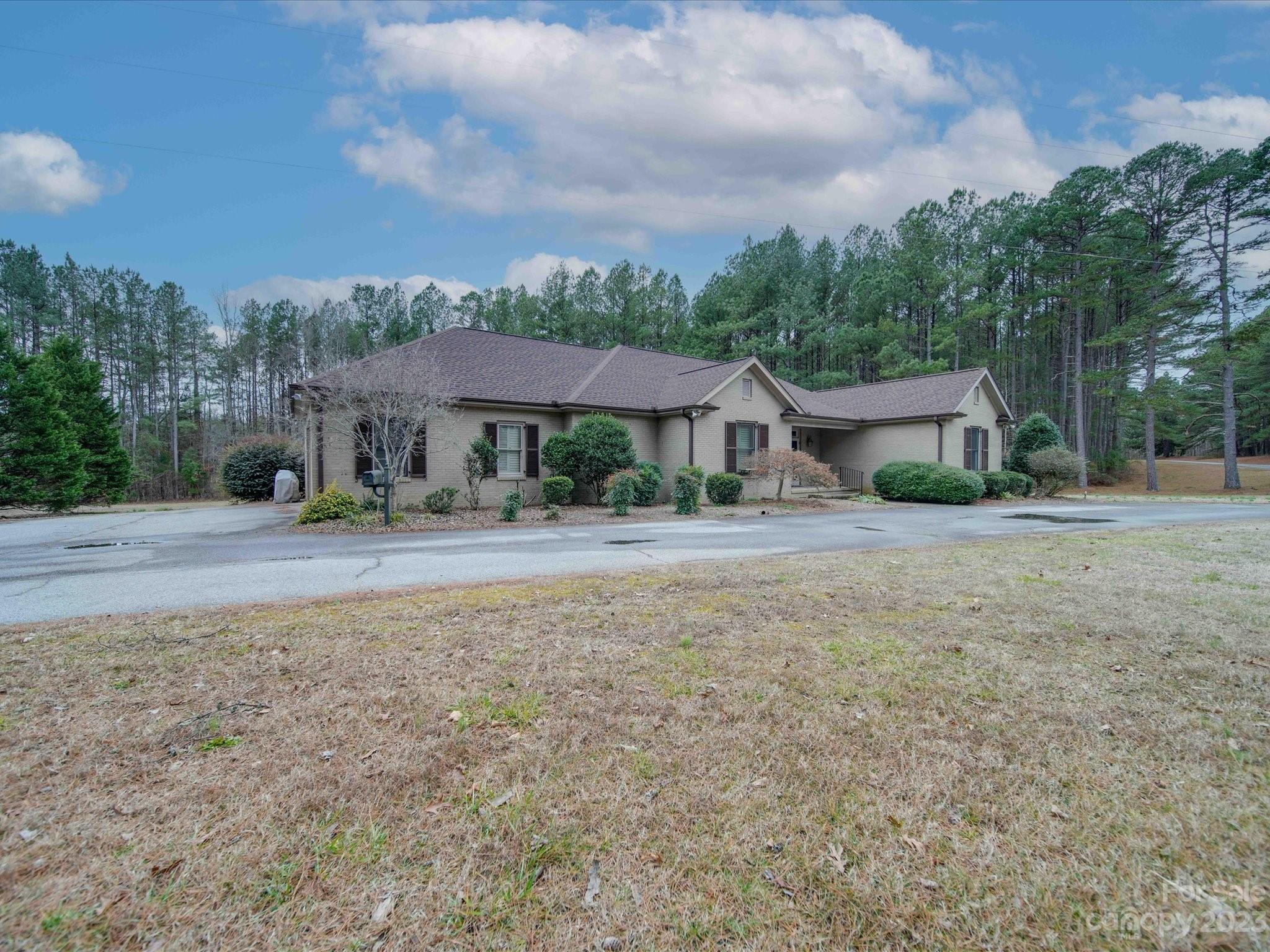 1939 Neel Road Salisbury, NC 28147 - Photo 3 of 48 a house with green field in front of it
