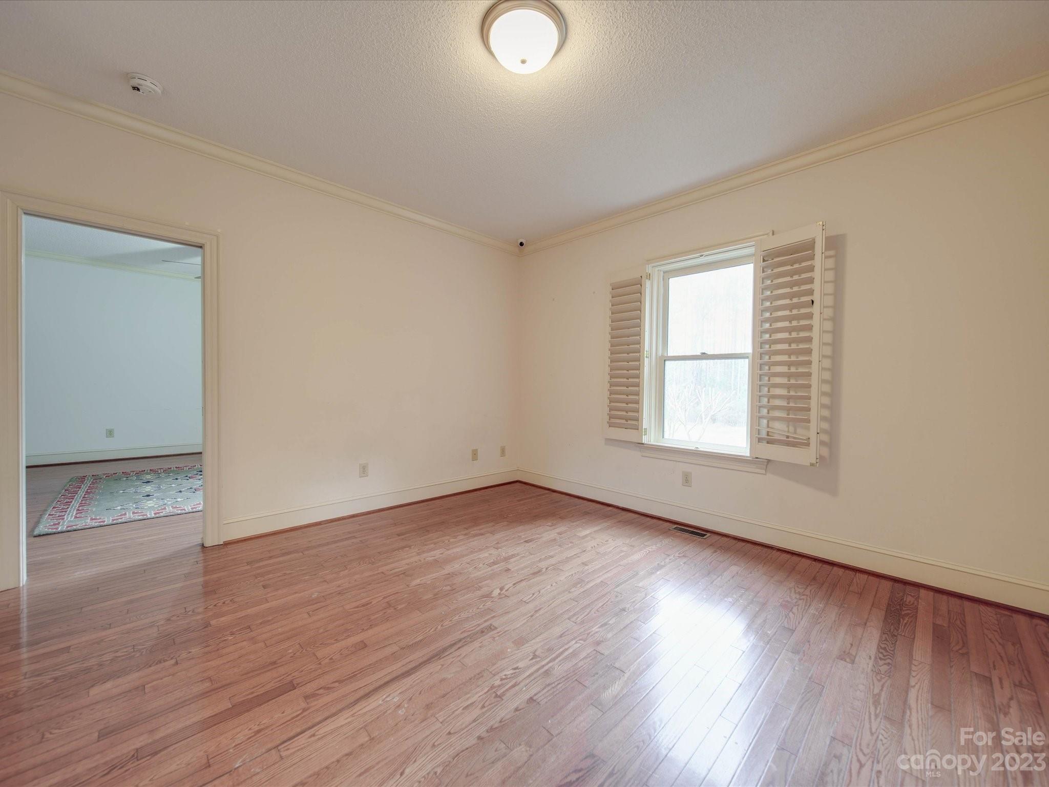 1939 Neel Road Salisbury, NC 28147 - Photo 34 of 48 an empty room with wooden floor and windows