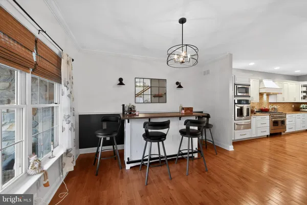 a kitchen with stainless steel appliances a stove top oven a sink dishwasher and a refrigerator