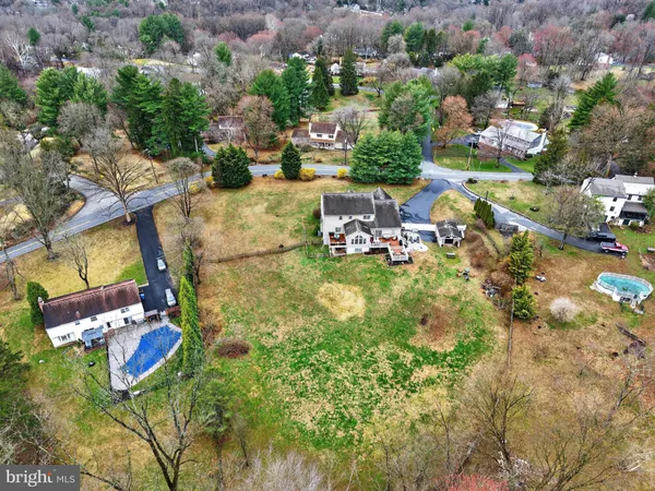 an aerial view of residential houses with outdoor space and swimming pool