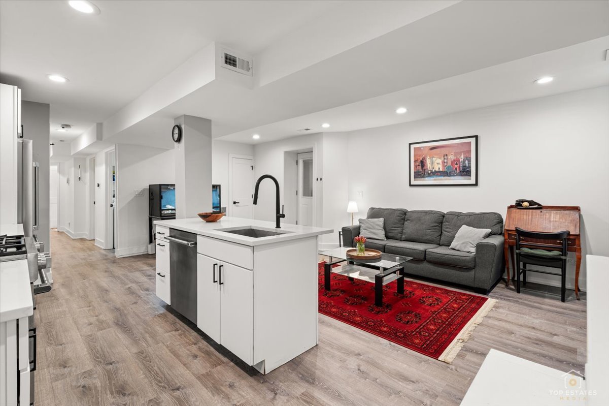 3432 West Belden Avenue, Unit G Chicago, IL 60647 - Photo 14 of 32 a living room with furniture and a flat screen tv