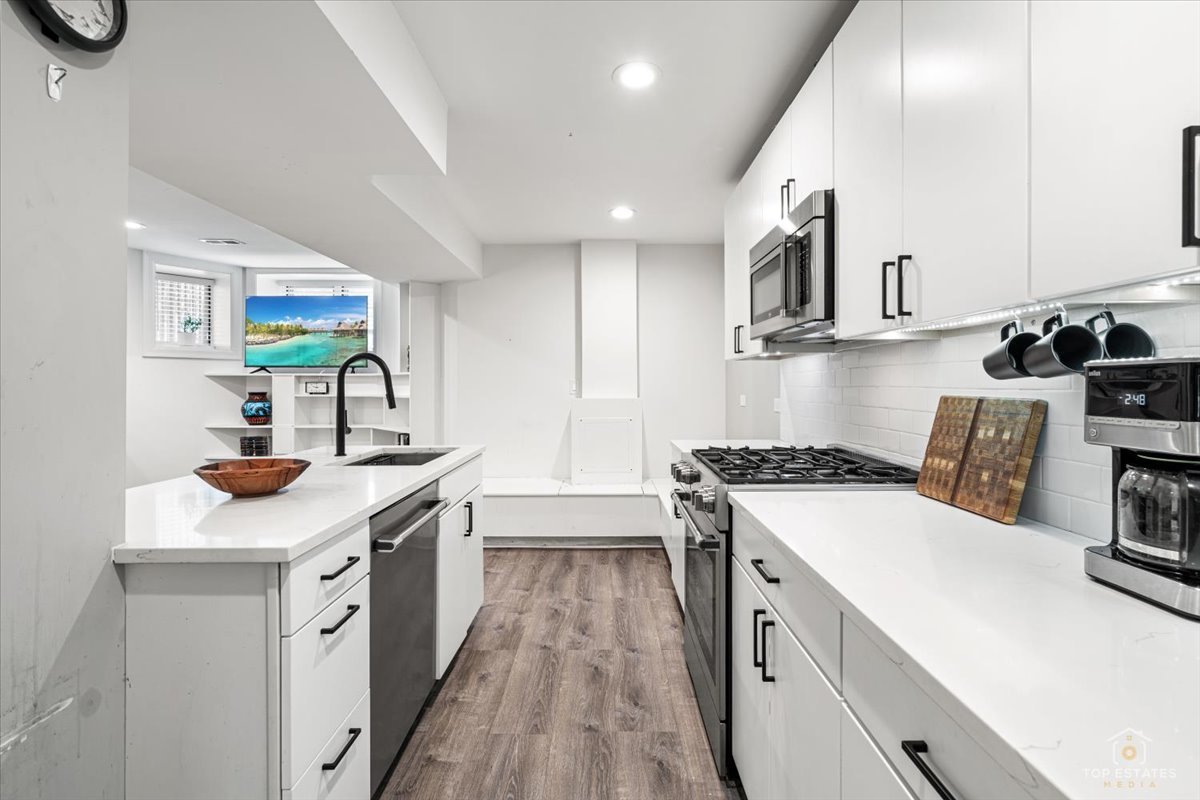 3432 West Belden Avenue, Unit G Chicago, IL 60647 - Photo 15 of 32 a kitchen with stainless steel appliances sink stove and cabinets