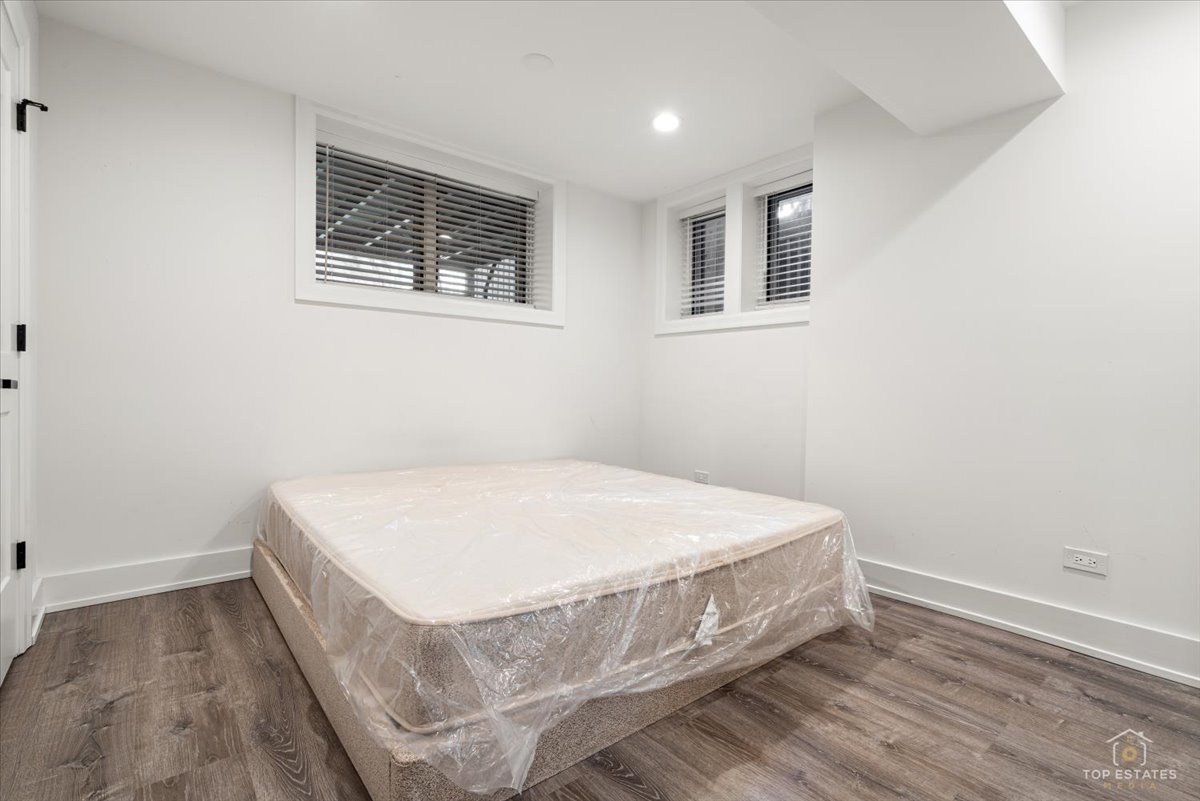 3432 West Belden Avenue, Unit G Chicago, IL 60647 - Photo 20 of 32 a bed sitting in a bedroom next to a window