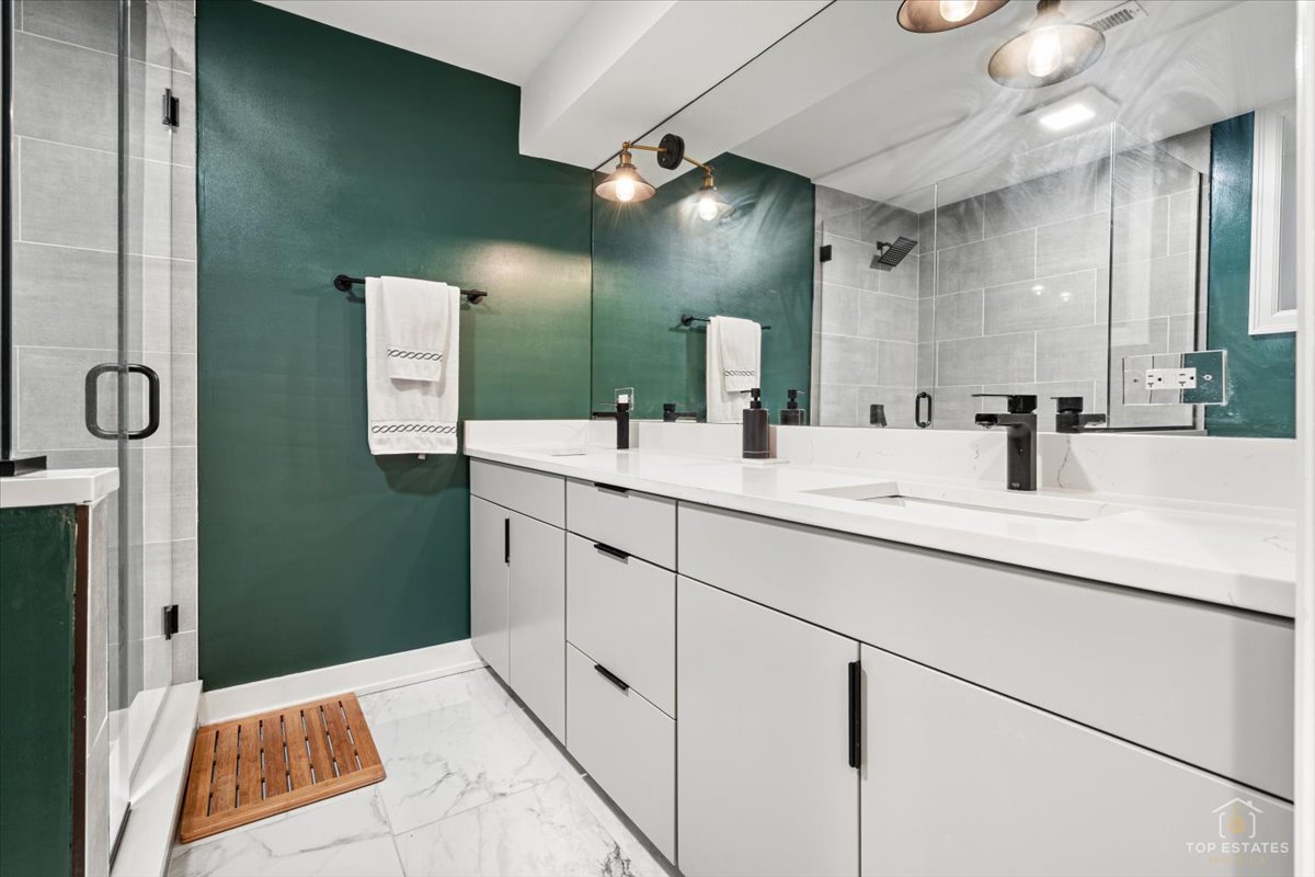 3432 West Belden Avenue, Unit G Chicago, IL 60647 - Photo 23 of 32 a bathroom with a sink and a mirror
