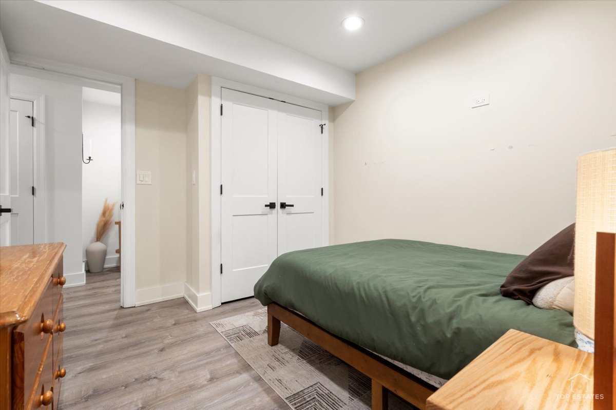 3432 West Belden Avenue, Unit G Chicago, IL 60647 - Photo 27 of 32 a bedroom with a bed and wooden floor