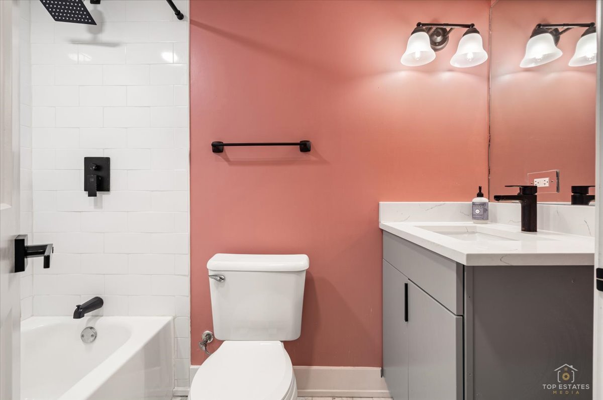 3432 West Belden Avenue, Unit G Chicago, IL 60647 - Photo 28 of 32 a bathroom with a sink a toilet and shower