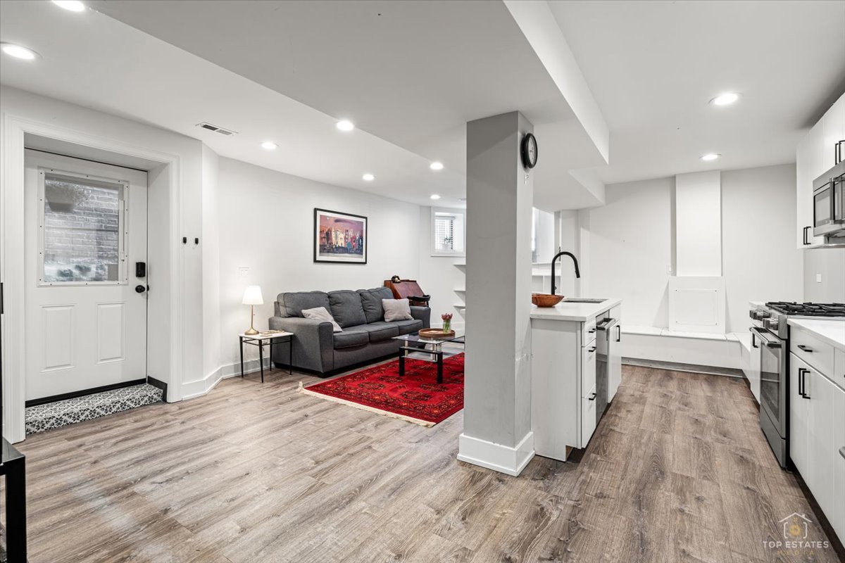 3432 West Belden Avenue, Unit G Chicago, IL 60647 - Photo 4 of 32 a living room with furniture and a wooden floor