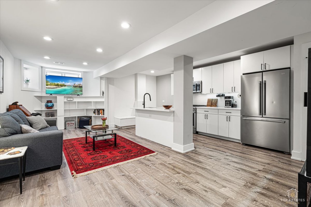 3432 West Belden Avenue, Unit G Chicago, IL 60647 - Photo 5 of 32 a living room with furniture wooden floor and a fireplace