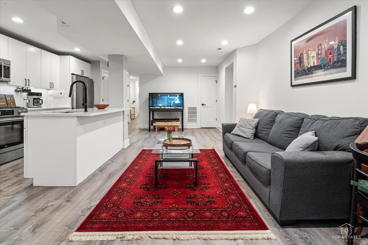 3432 West Belden Avenue, Unit G Chicago, IL 60647 - Photo 10 of 32 a living room with furniture flat screen tv and a rug