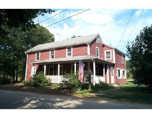 29 North Sullivan Road Charlton, MA 01507 - Photo 1 of 6 a view of a white house with large windows and a small yard