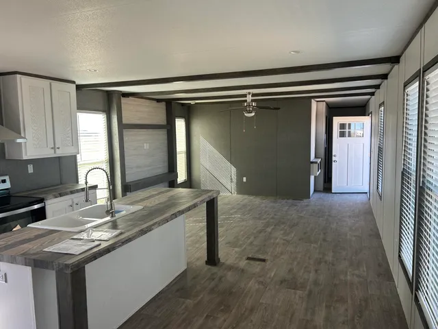 a kitchen with stainless steel appliances granite countertop a sink and cabinets