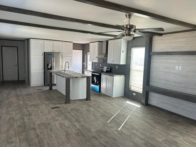 a kitchen with stainless steel appliances granite countertop a refrigerator and a sink