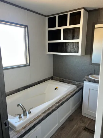 a bathroom with a tub and a sink
