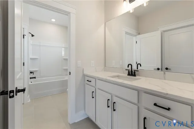a bathroom with a tub sink and mirror