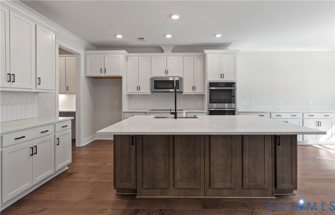 3708 Rocketts Rdg Drive Goochland, VA 23063 - Photo 7 of 29 a kitchen with kitchen island a sink stainless steel appliances and cabinets