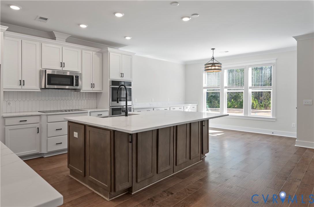 3708 Rocketts Rdg Drive Goochland, VA 23063 - Photo 8 of 29 a kitchen with stainless steel appliances granite countertop a sink stove and microwave