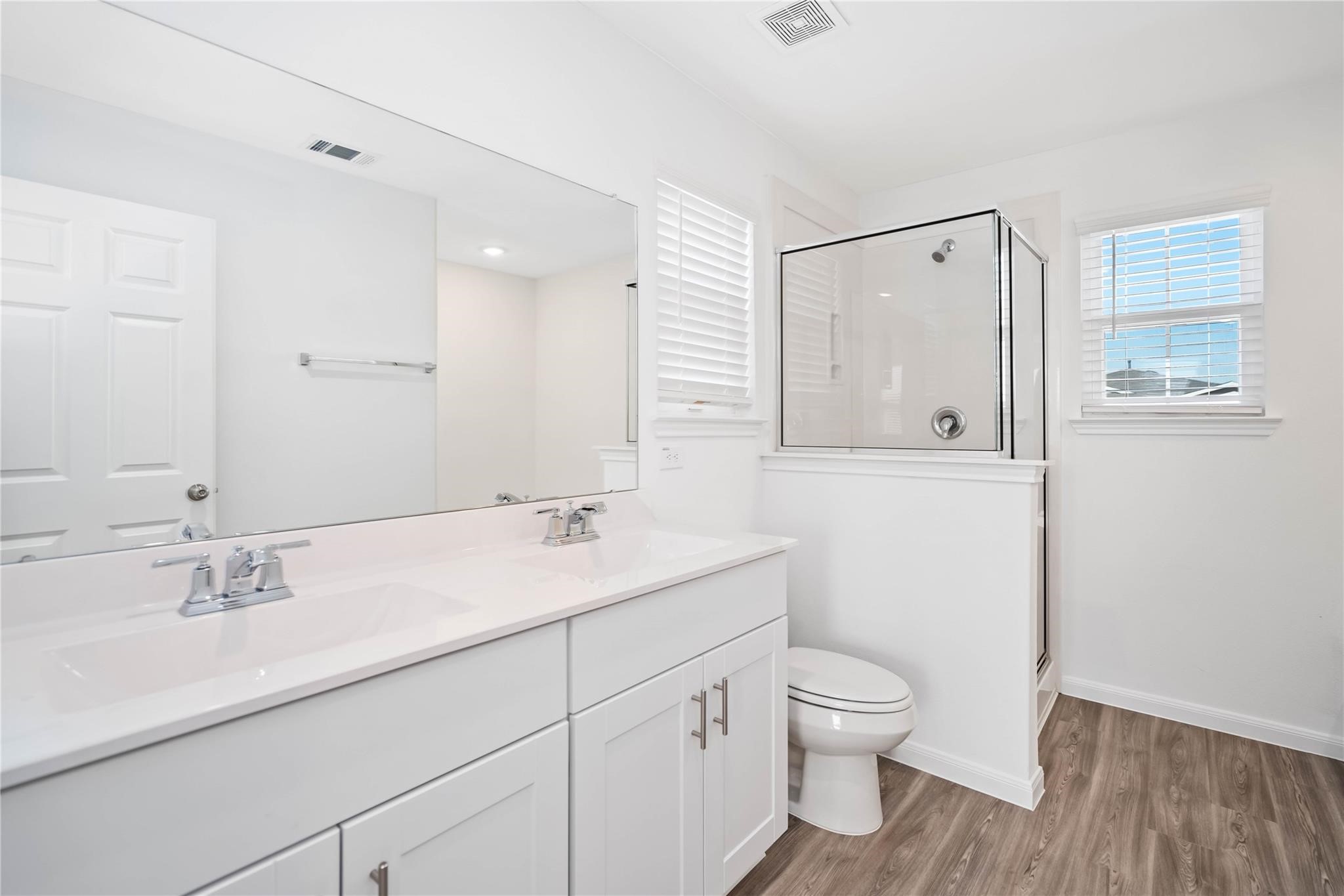 7327 Madison Commons Lane Houston, TX 77075 - Photo 4 of 6 a bathroom with a granite countertop sink a toilet and a mirror