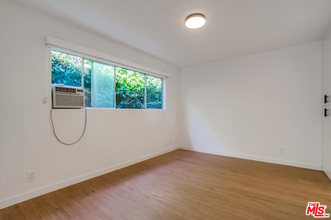 18241 Coastline Drive, Unit 2 Malibu, CA 90265 - Photo 19 of 45 an empty room with a glass door and glass door