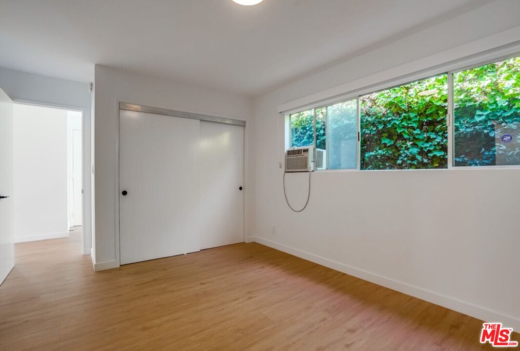 18241 Coastline Drive, Unit 2 Malibu, CA 90265 - Photo 20 of 45 a view of a room with wooden floor and windows