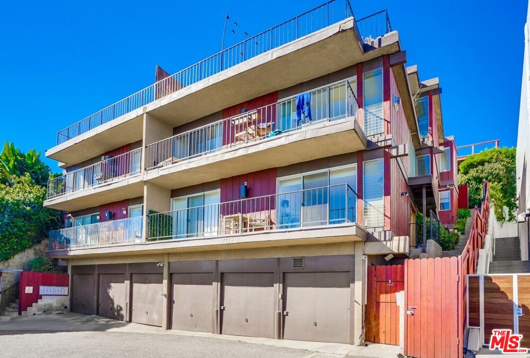 18241 Coastline Drive, Unit 2 Malibu, CA 90265 - Photo 2 of 45 a tall building with large windows