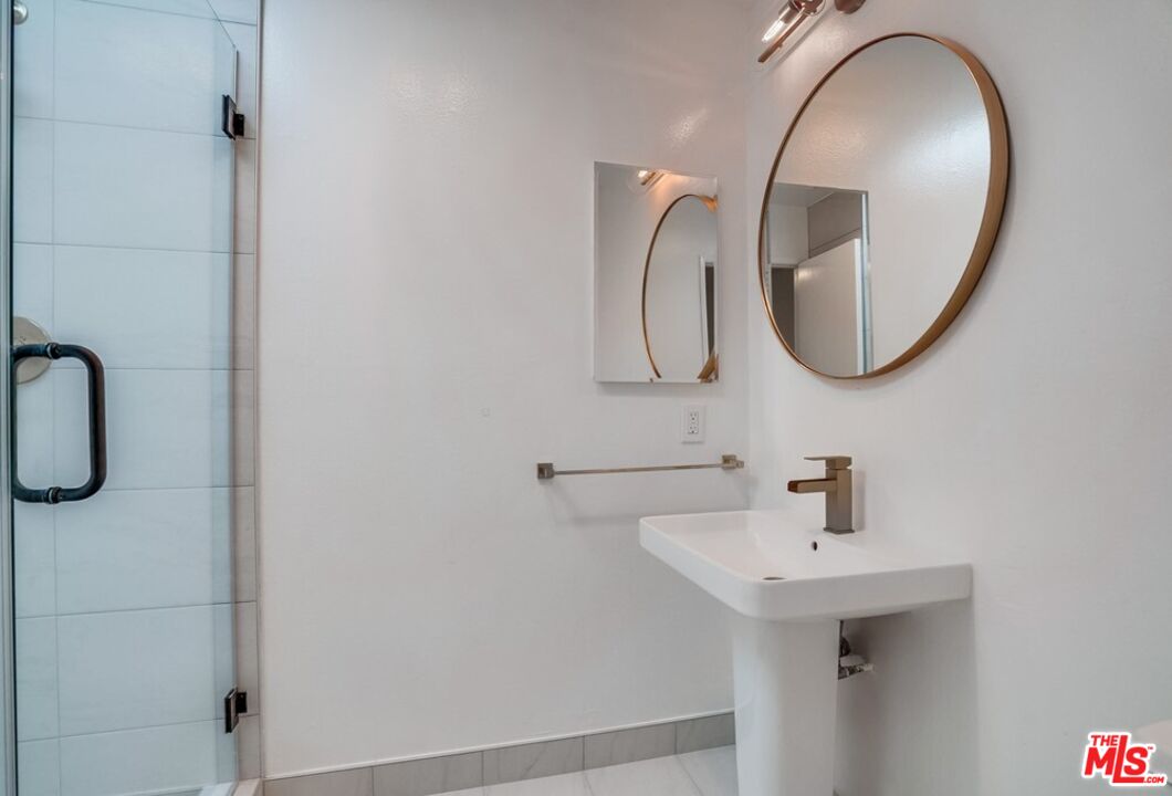 18241 Coastline Drive, Unit 2 Malibu, CA 90265 - Photo 24 of 45 a bathroom with a sink and mirror