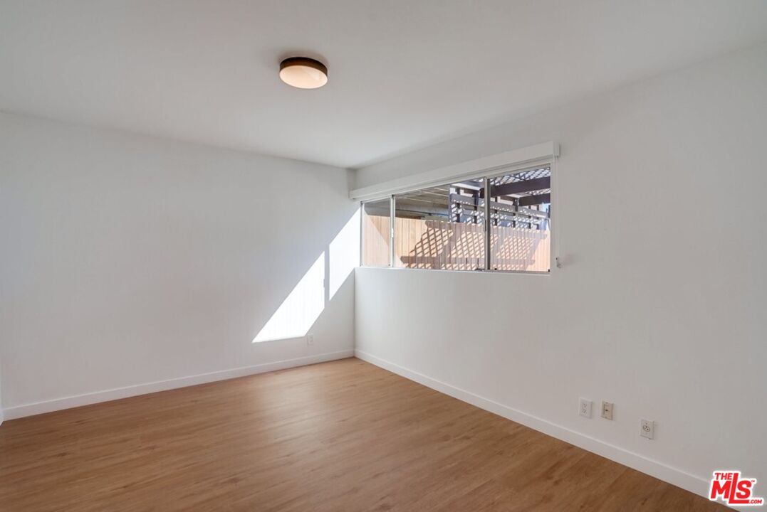 18241 Coastline Drive, Unit 2 Malibu, CA 90265 - Photo 25 of 45 a view of empty room with wooden floor