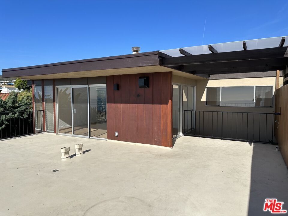 18241 Coastline Drive, Unit 2 Malibu, CA 90265 - Photo 45 of 45 a front view of a house with a yard
