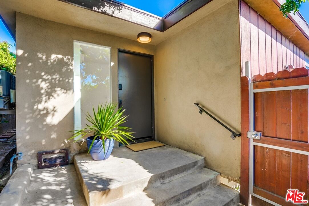 18241 Coastline Drive, Unit 2 Malibu, CA 90265 - Photo 5 of 45 a potted plant in front of a door