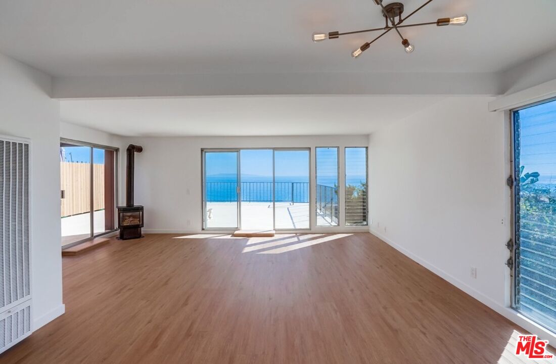 18241 Coastline Drive, Unit 2 Malibu, CA 90265 - Photo 8 of 45 wooden floor in an empty room with a window