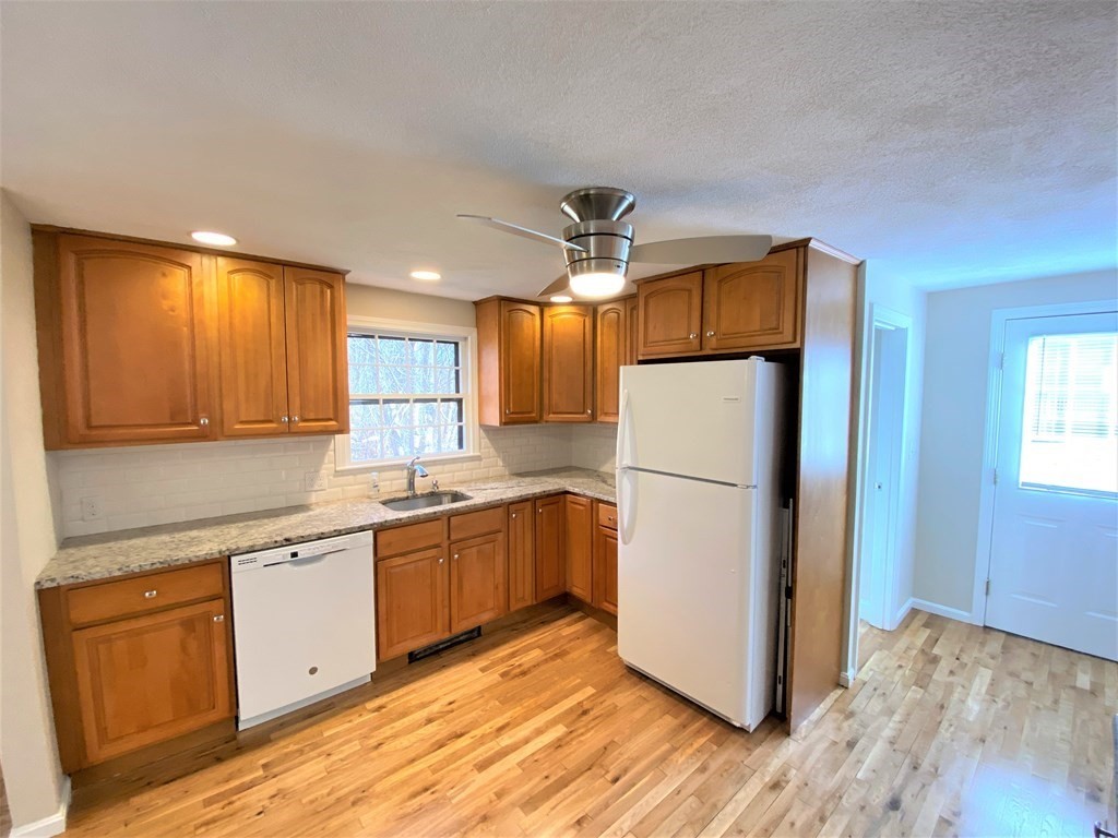 15 Appaloosa Drive, Unit 15 Methuen, MA 01844 - Photo 11 of 23 a kitchen with a refrigerator sink and cabinets