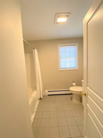 a bathroom with a white bath tub and a shower